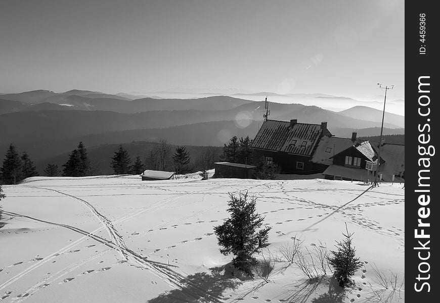 Small hostel in mountains in background big mountain. Winter Time. Small hostel in mountains in background big mountain. Winter Time