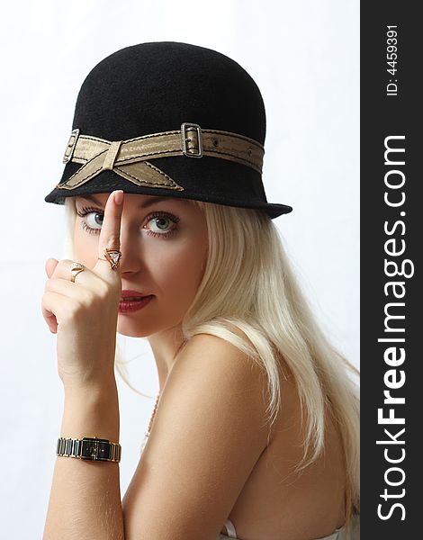 Portrait of the nice girl in hat with watch