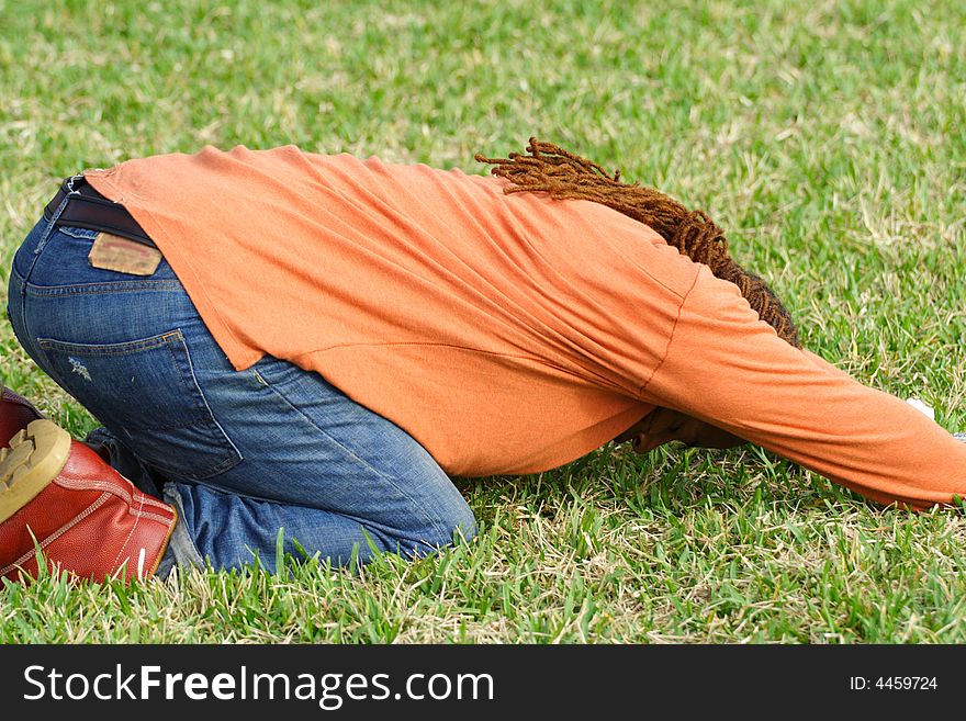 Man doing yoga on the green grass. Man doing yoga on the green grass