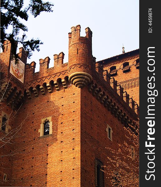 A view of an ancient castle in Turin, Italy, with a natural frame of trees and a warm light. A view of an ancient castle in Turin, Italy, with a natural frame of trees and a warm light