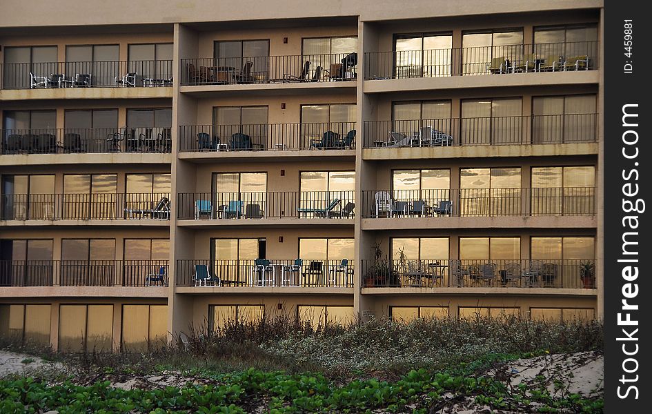 Condominium windows reflect the sunrise on the beach at South Padre Island, Texas. Condominium windows reflect the sunrise on the beach at South Padre Island, Texas.