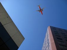 Plane Flying Over City Stock Image