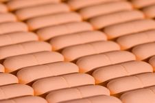 Rows Of Pink Pills Over White Stock Image