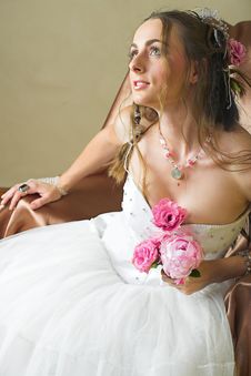 Bride With Brown Long Hair Sitting In Chair Stock Photo