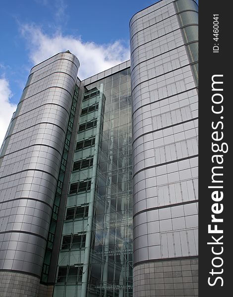 Looking up at a tall silver office building