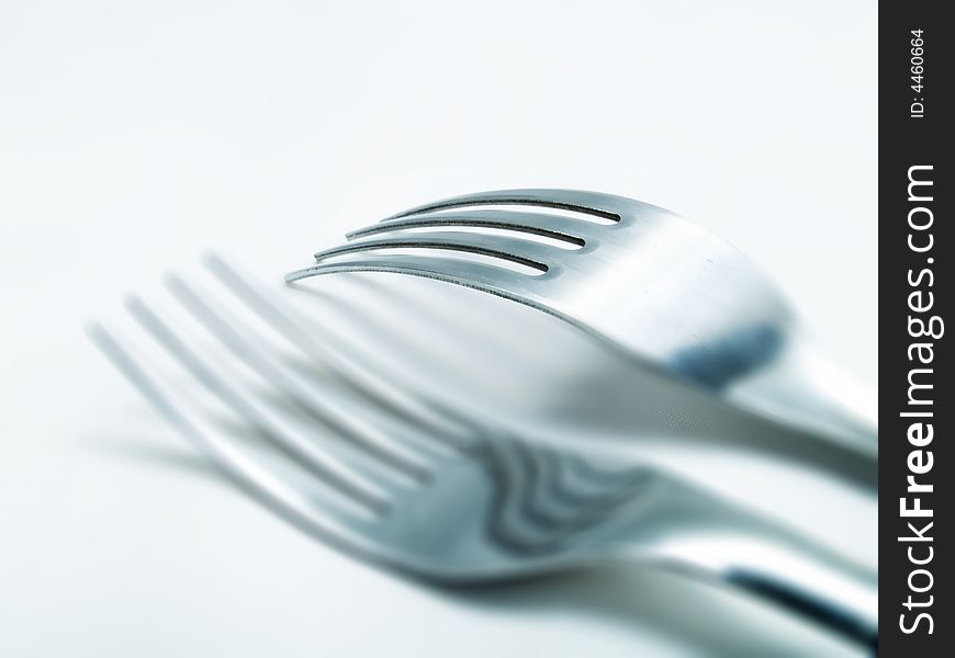 Two forks on a white background