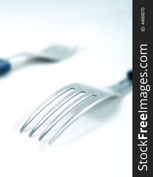 Two forks on a white background