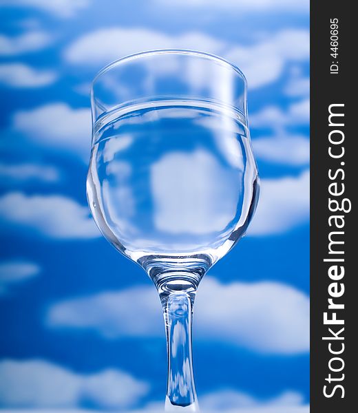 Glass of water over a blue sky