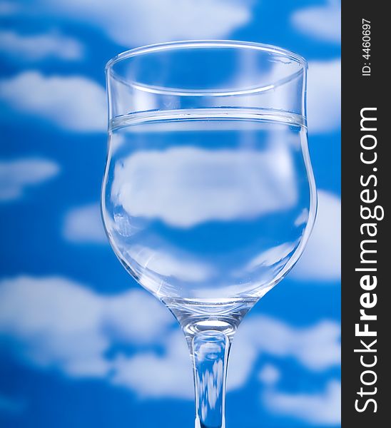 Glass of water over a blue sky