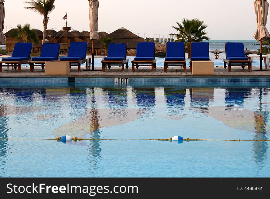 Pool in a tropical resort with beach in the horizon