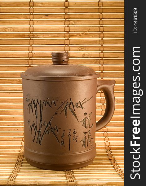 Clay cup of tea on bamboo background