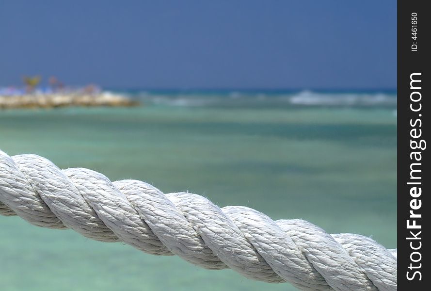 White rope fence on tropical beach. Background.