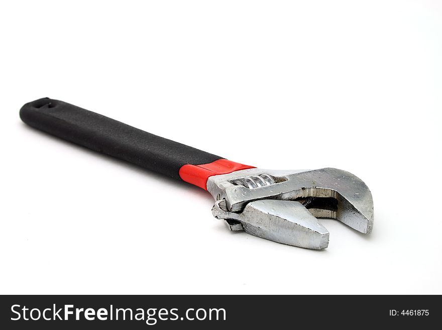 Adjustable wrench over a white surface