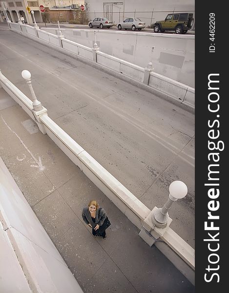 Wide shot from above of woman on a sidewalk. Wide shot from above of woman on a sidewalk