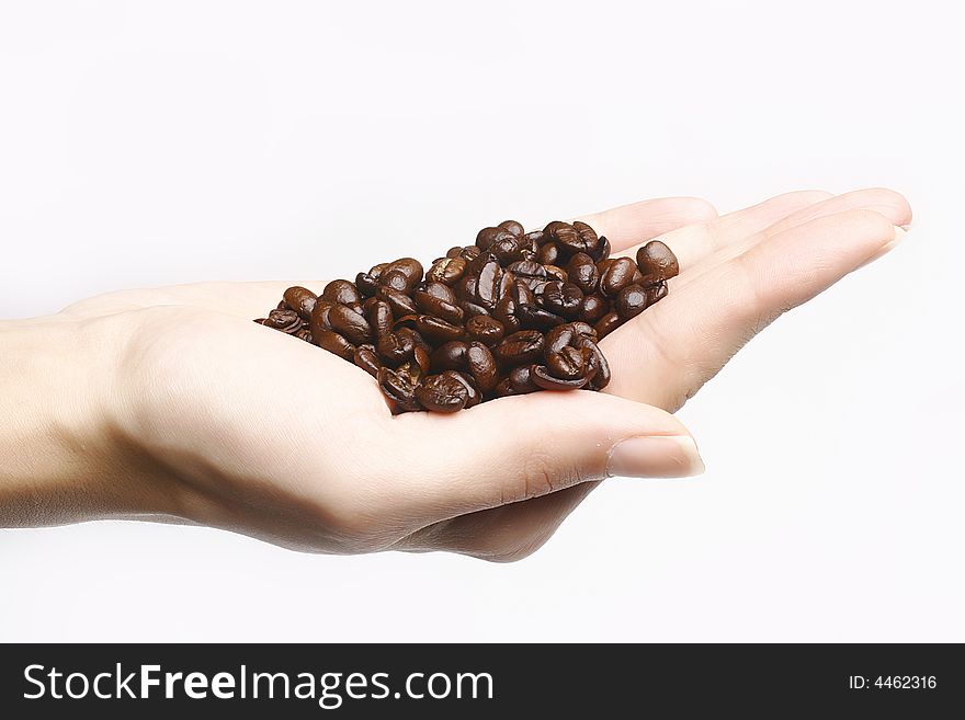 Coffee beans in woman hand