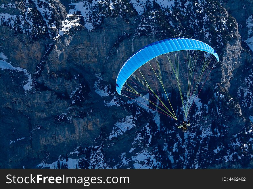 Paraglider hovering in the mountains