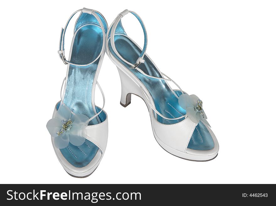 White female shoes with an artificial flower on a white background