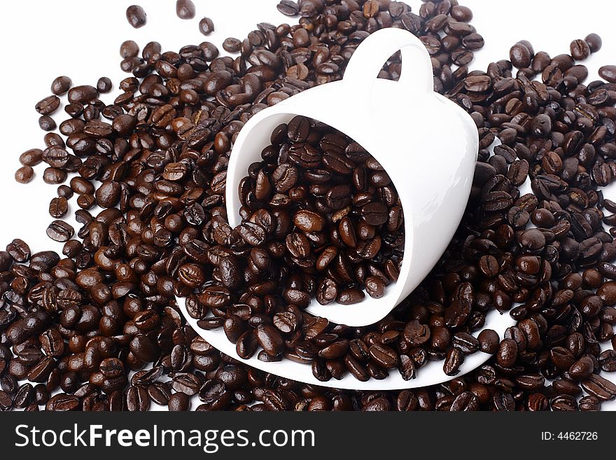 Brown coffee beans in cup