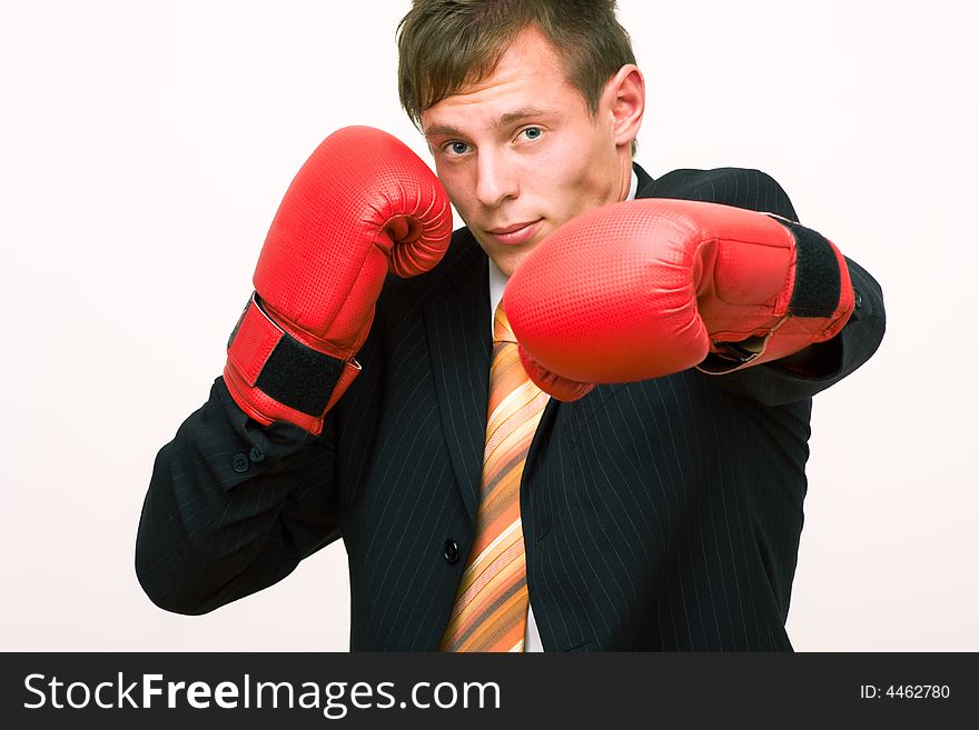 Angry young boxing businessman on white