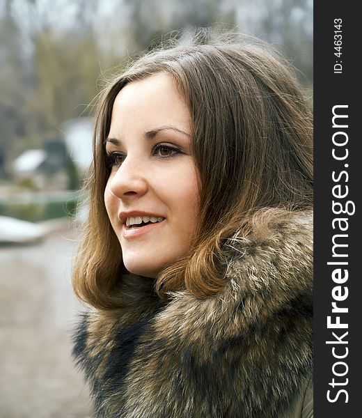 Smiling beautiful girl in fur coat