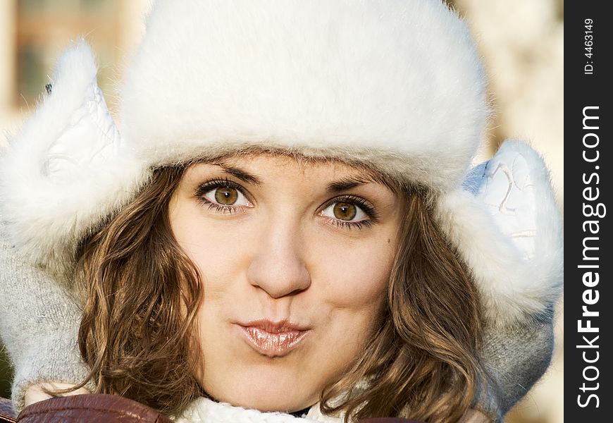 Portrait of grimacing girl in fur hat. Portrait of grimacing girl in fur hat