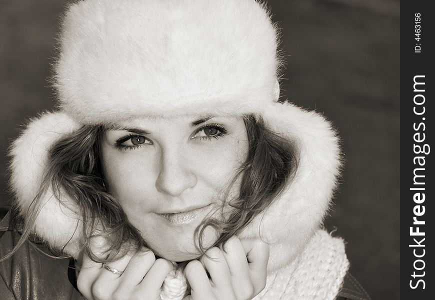 Portrait of smiling girl in fur hat, sepia. Portrait of smiling girl in fur hat, sepia