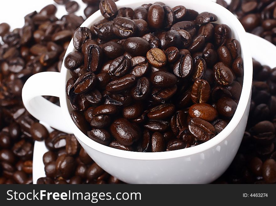 Cup full of coffee beans closeup