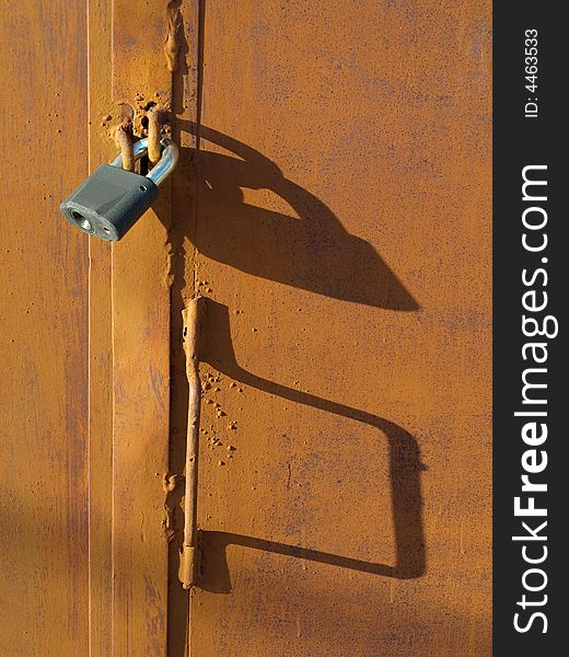 Lock on rusty door with shawdows