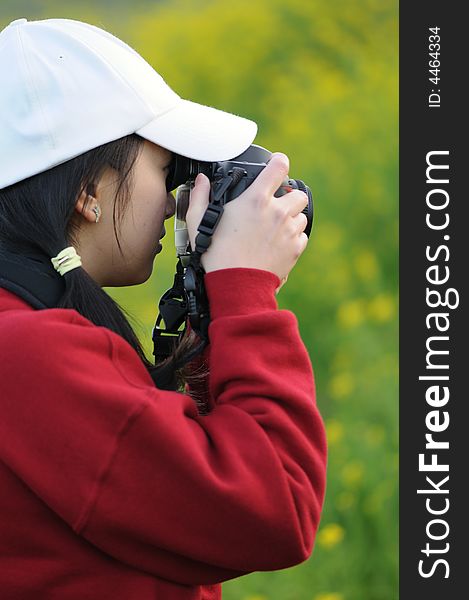 A woman photographer focusing on her subject. A woman photographer focusing on her subject