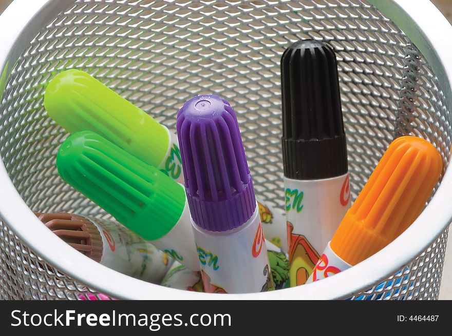 Child's felt-tip pens-markers in a white tumbler. Close-up.