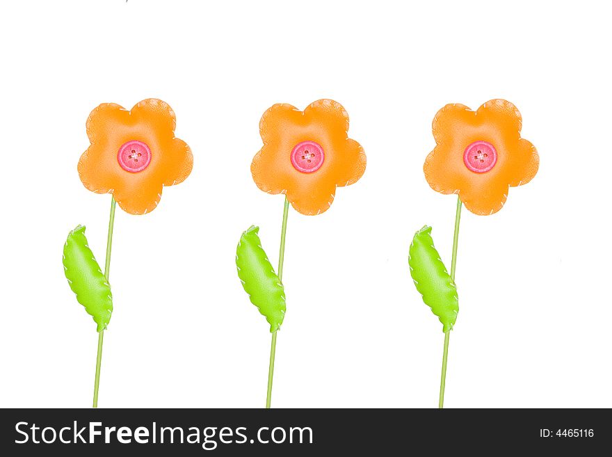 Three orange toy flowers  isolated on white