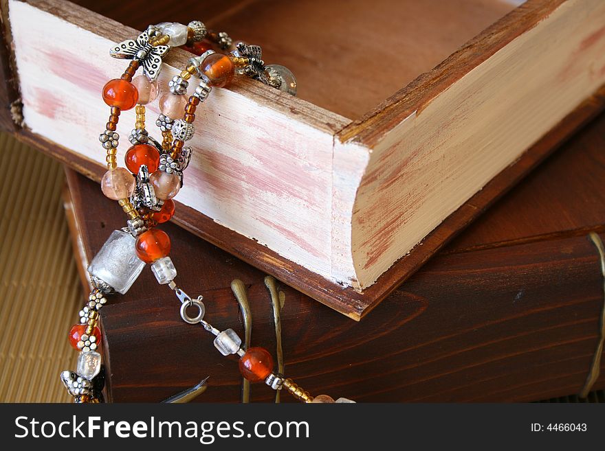 Orange Jewellery hanging from an open wooden jewellery box