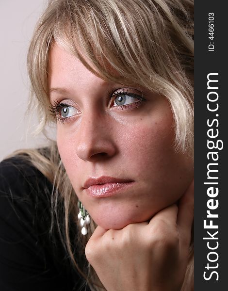 Blond Female model on a white background wearing a black top. Blond Female model on a white background wearing a black top