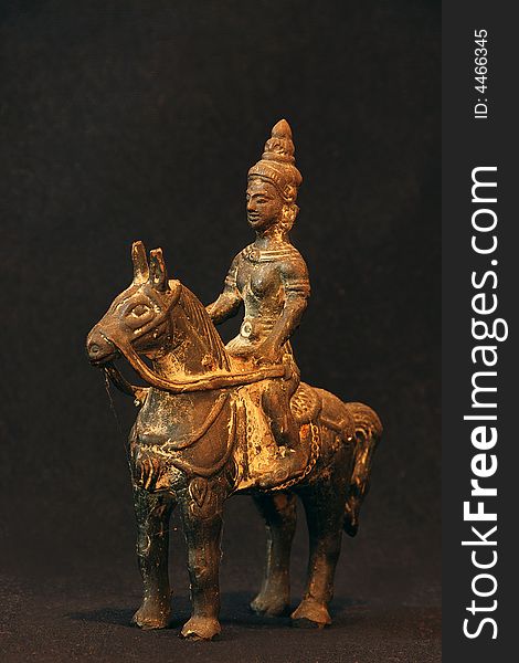 A small bronze stature of an old chinese soldier on horseback. A small bronze stature of an old chinese soldier on horseback
