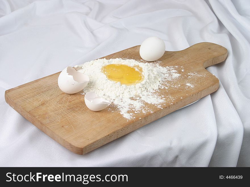 Eggs And A Flour On A Board