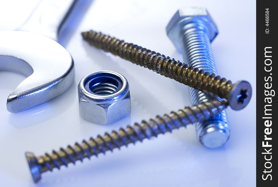 Screws and spanner on table