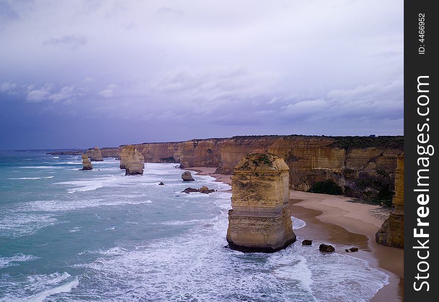 Eroded cliffs - stacks in ocean waves, Victoria, Australia. Eroded cliffs - stacks in ocean waves, Victoria, Australia