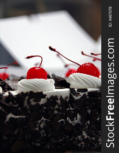 Black forest cake decorated with cherries.