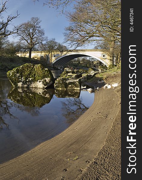 The sandy bank of the river Lune with the modern road bridge at Kirkby Lonsdale, Cumbria, England