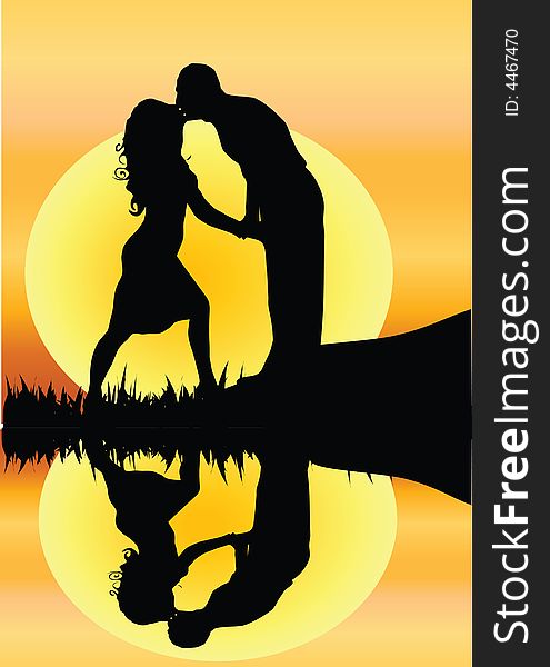 Silhouette of young romantic couple kissing by a river