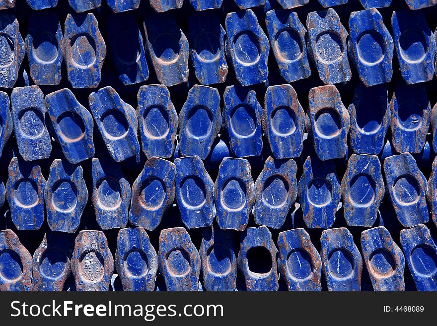 A stack of scaffold posts used to build a construction platform looking end on