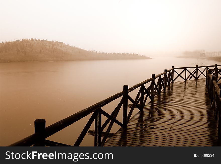 The wooden bridge in fog