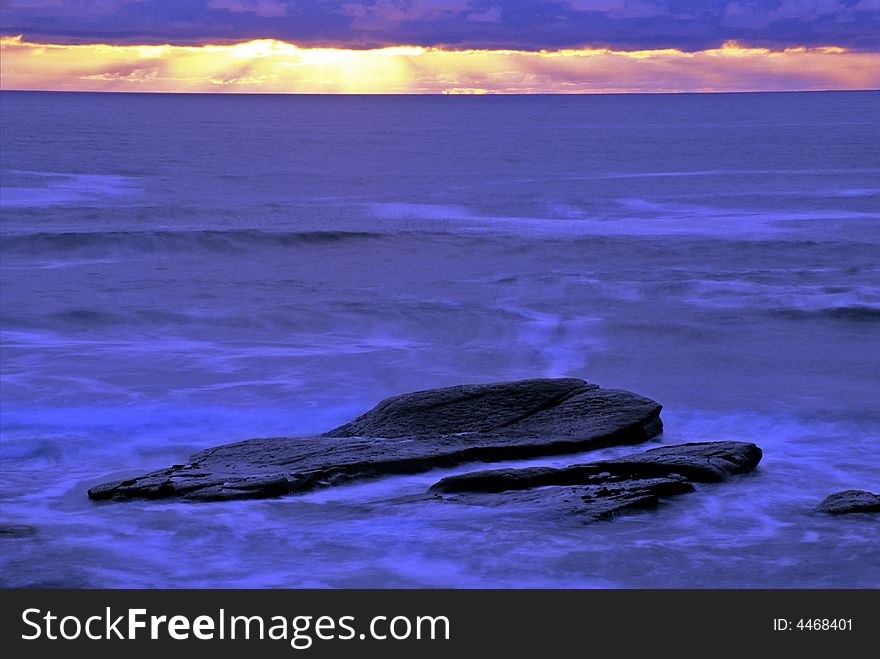 Large rocks in the shallows on the California coastline. Large rocks in the shallows on the California coastline