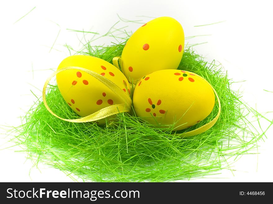 Three yellow easter egge with green grass isolated on white. Three yellow easter egge with green grass isolated on white