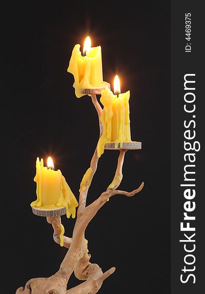 Three candles on a wooden candlestick