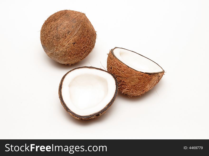 One cracked and one unbroken coconuts isolated on white. One cracked and one unbroken coconuts isolated on white