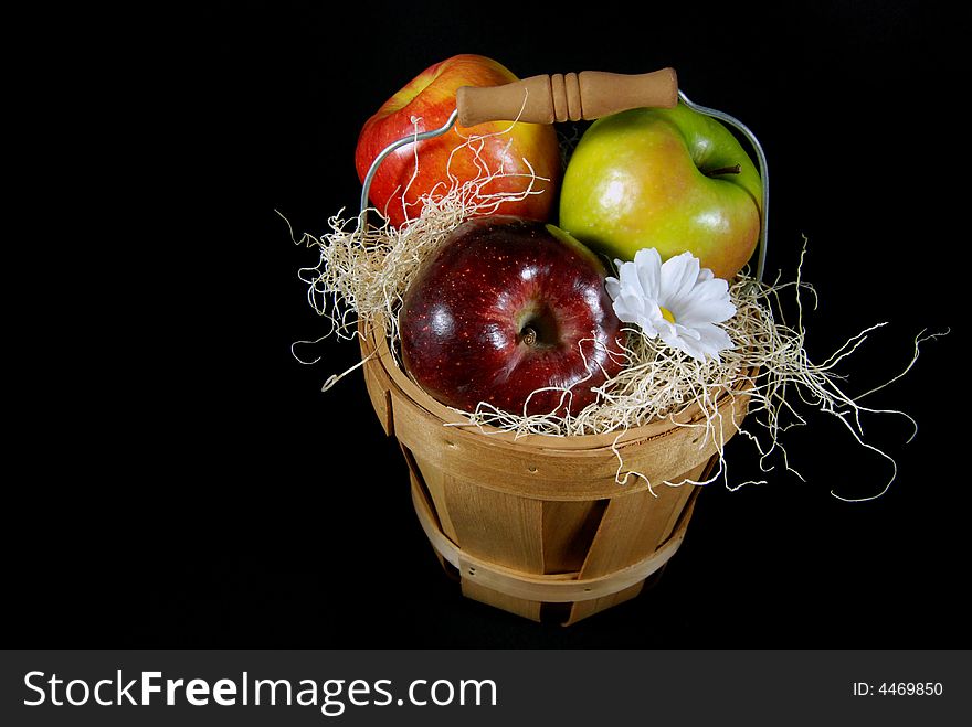 Apples in a wooden basket on black. Apples in a wooden basket on black.