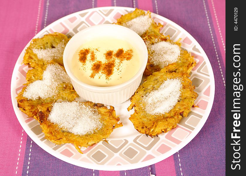 Fried potato cakes with sugar and spicy sauce