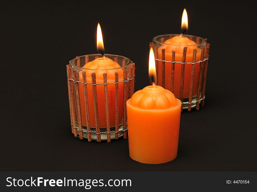 Fiery orange candles against black background