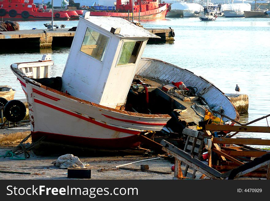 Wreck of a wooden boat in a boatyard . Wreck of a wooden boat in a boatyard